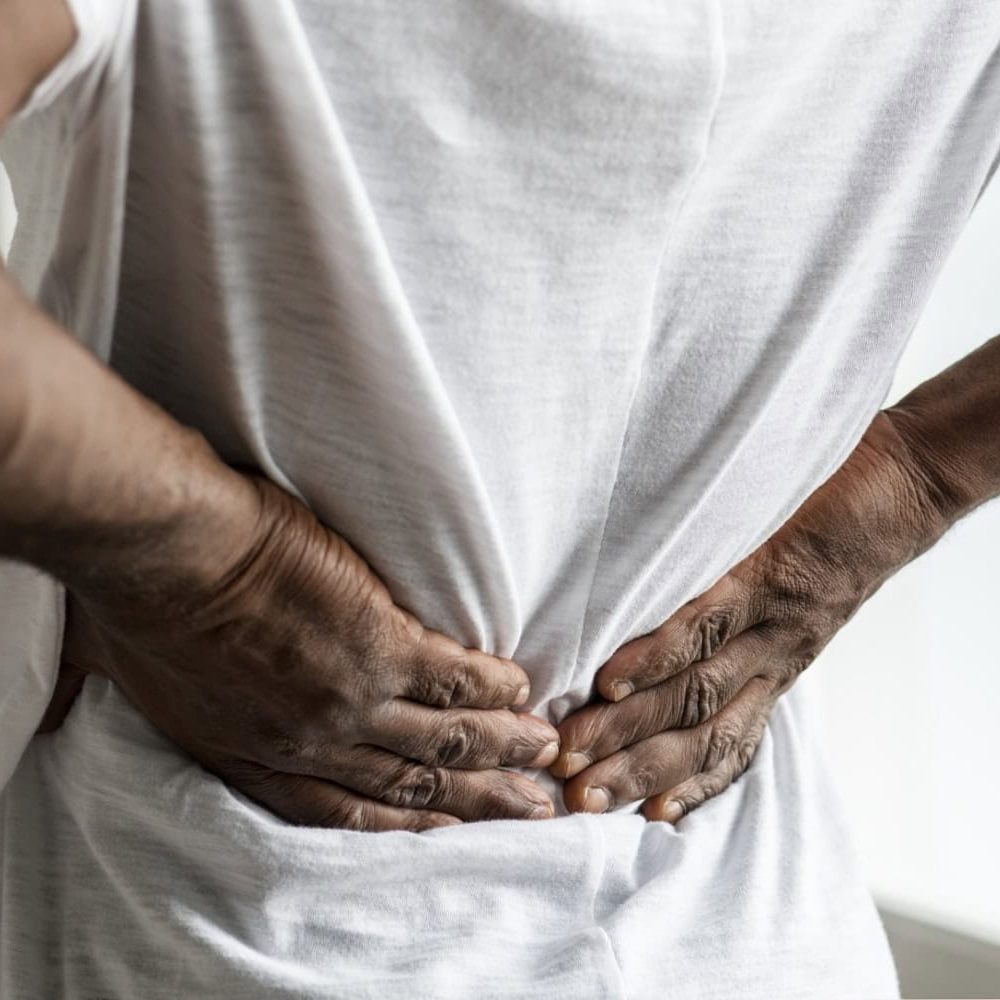 black man holding his back. Suffering from back-pain- sciatica
